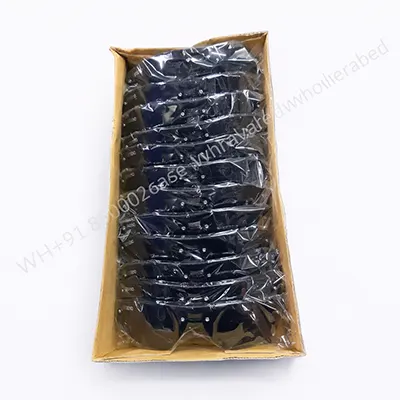 Bulk packed black safety eyewear stacked in a brown carton, sealed in clear plastic on white background for wholesale supply.