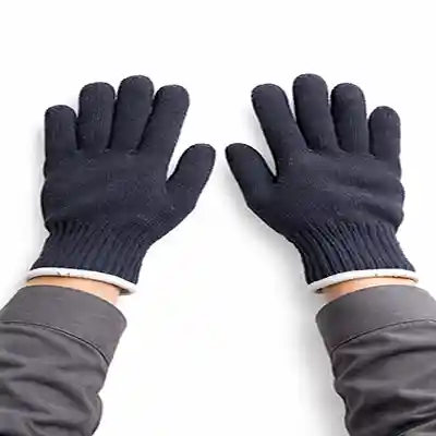 Navy blue cotton wollen safety gloves worn on both hands against white background, knitted texture with elastic cuffs for industrial protection.
